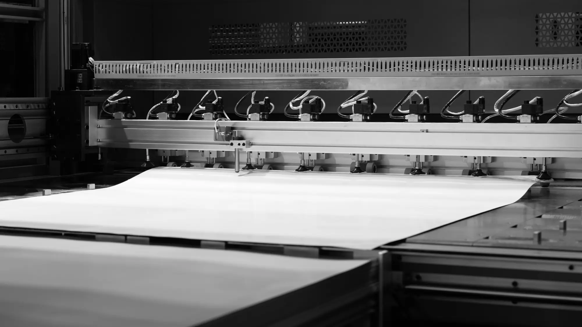 Sheets of paper feeding through an automated press feeder