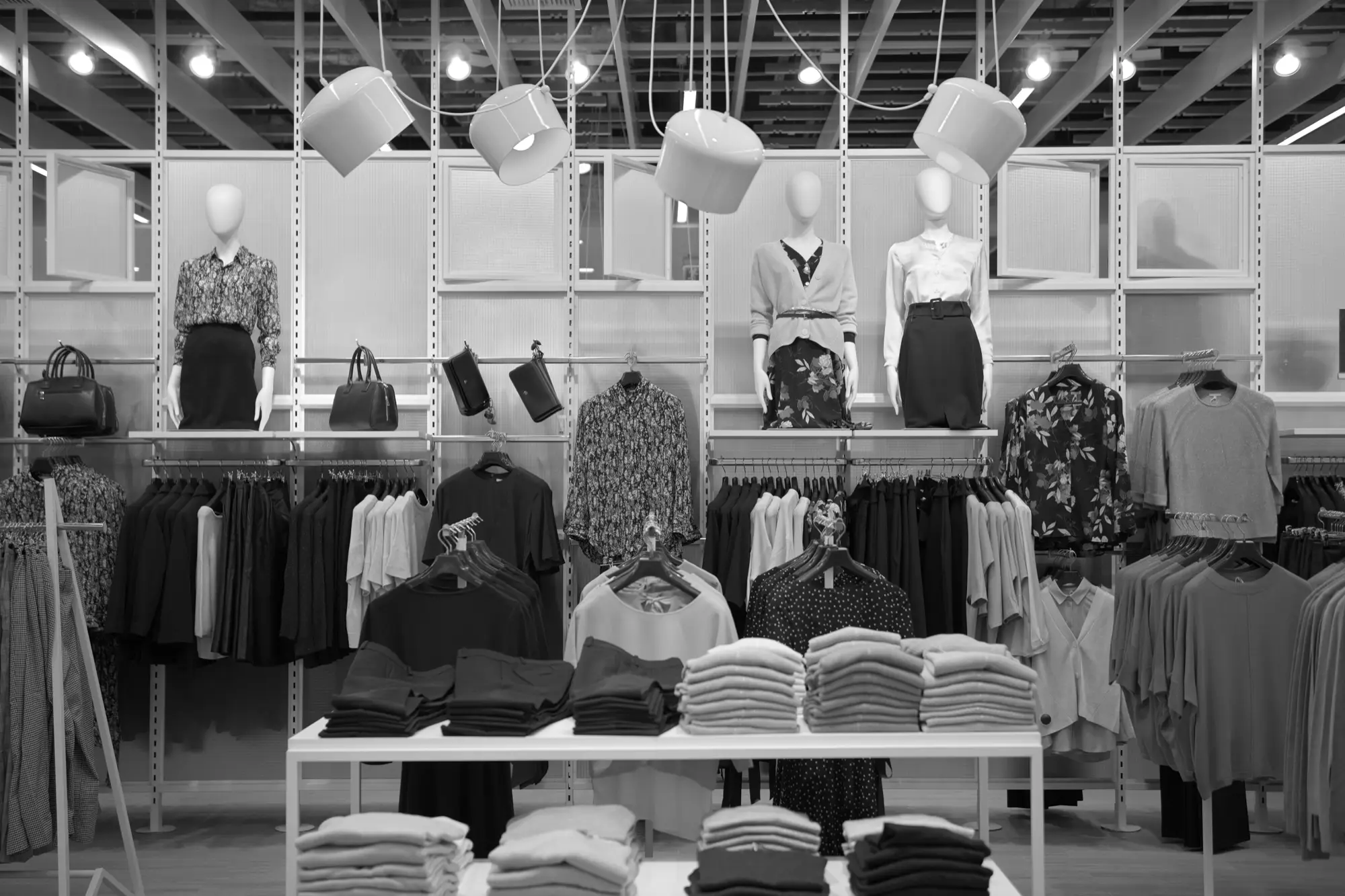 Retail apparel floor with folded stacks and mannequin displays