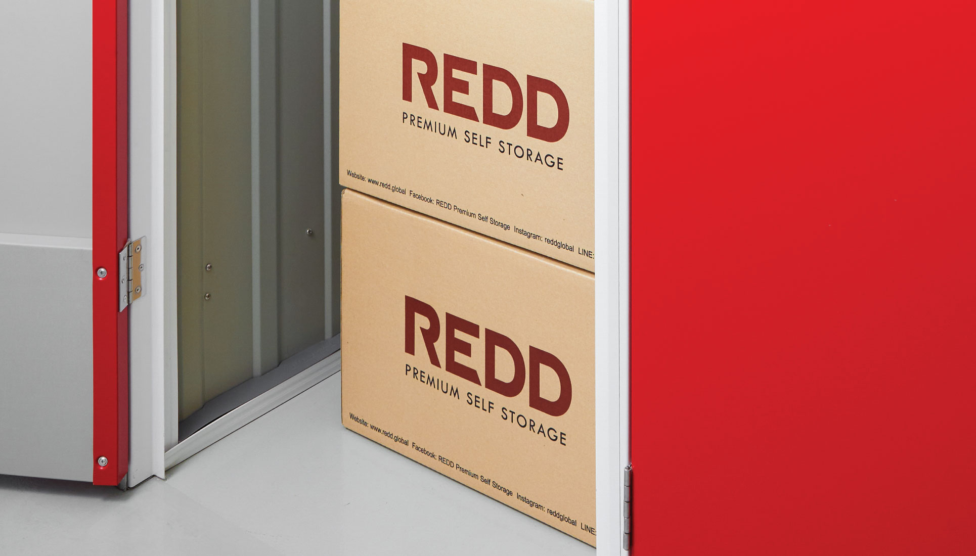 REDD-branded packing boxes stacked inside an open unit