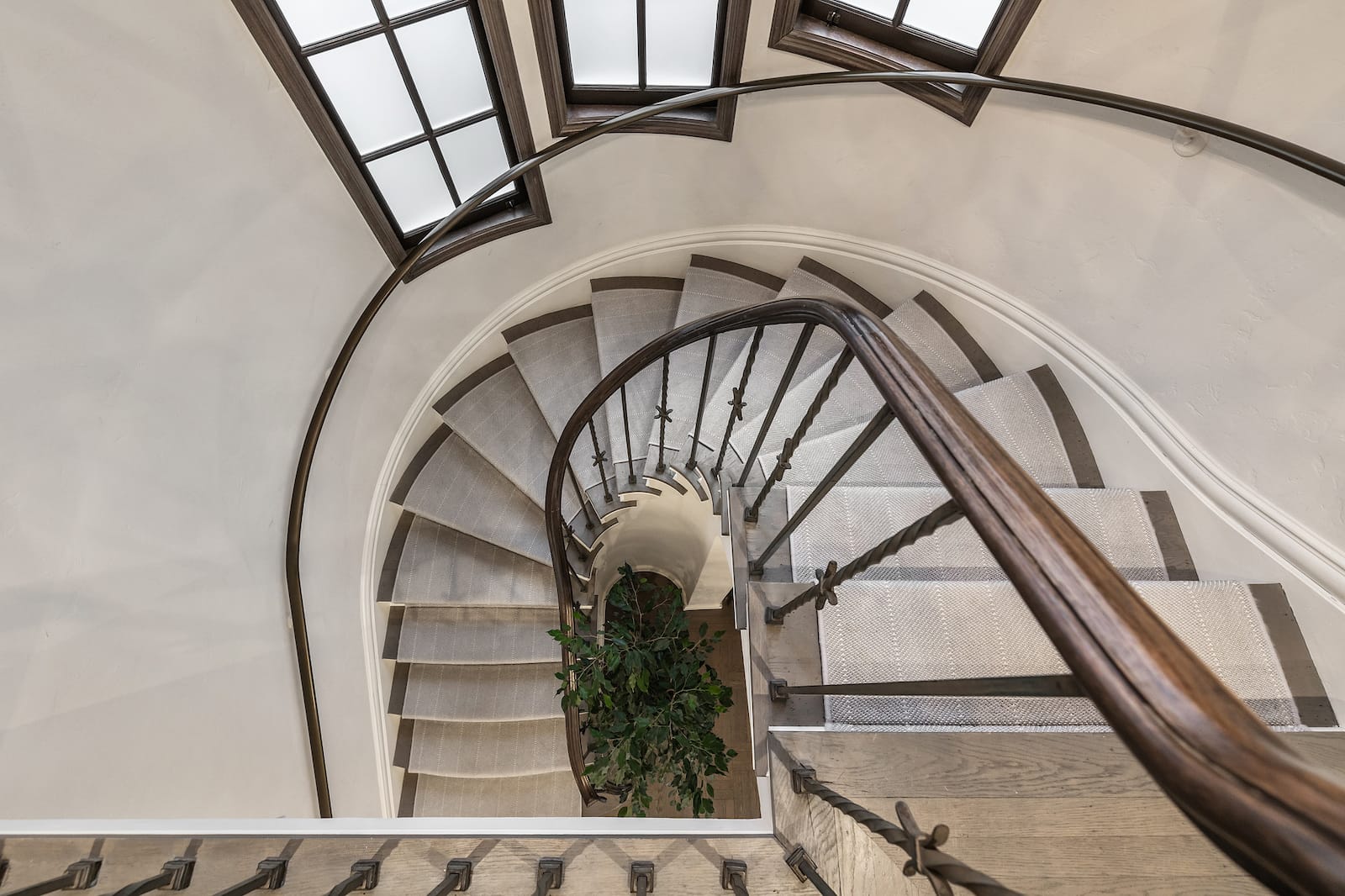Curved staircase spiraling down beneath leaded skylights on Marina Boulevard