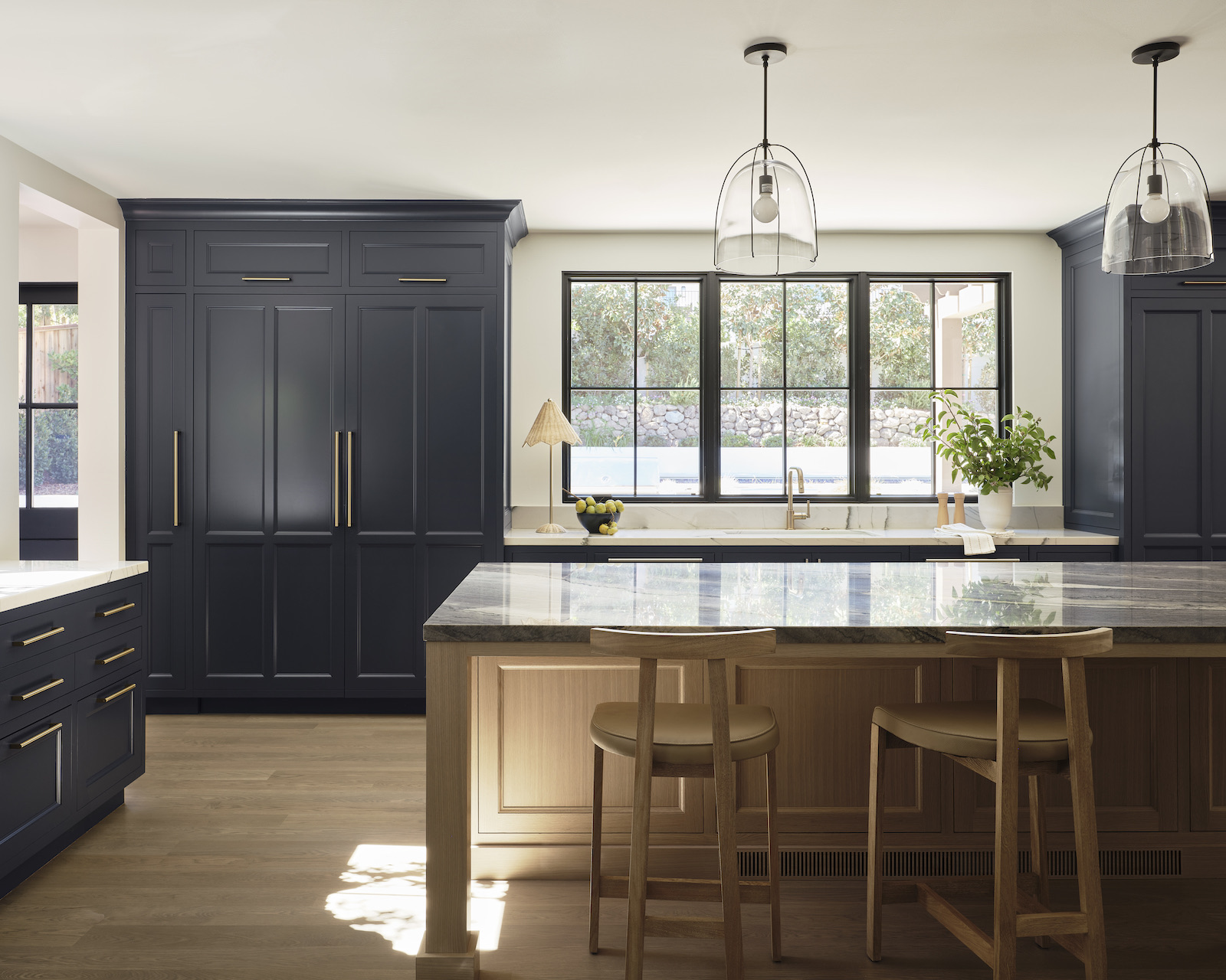 Navy panelled kitchen in Hillsborough with white-oak island and stone counters