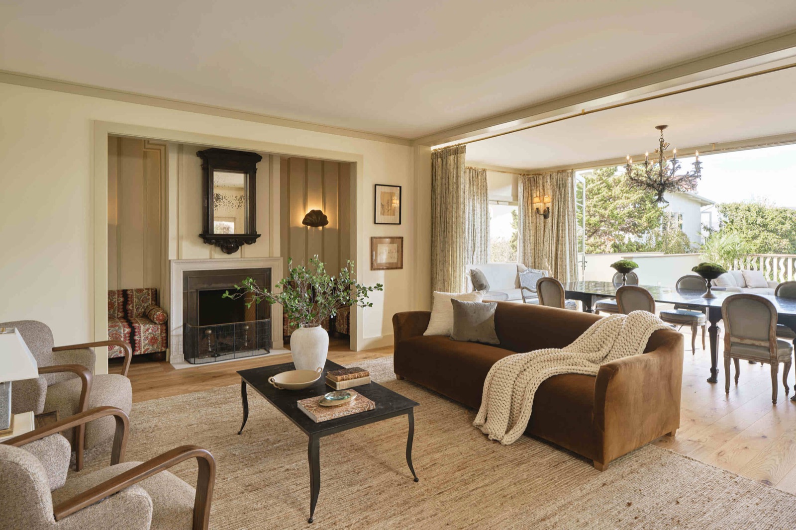 Sea Cliff living room opening onto a terrace under a wrought-iron chandelier